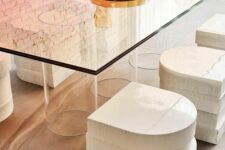 a beautiful modern dining table with glasses holding the ombre glass tabletop and eye-catchy stacked stools for a modern space