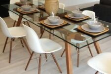 a chic modern table with wooden legs and a frame looks both modern and rustic and will add a touch of coziness to the space