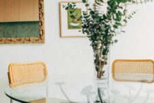 a cool dining table with a round glass tabletop and a metal base is a stylish idea for a modern dining space