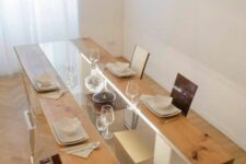 a creative dining table with a glass and wood tabletop and white legs plus built-in lights is a stylish idea for a modern dining room