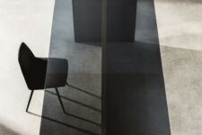 a large dining table with a minimalist wooden base and a smoked glass tabletop is a catchy idea for a contemporary or minimalist space