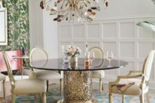 a refined and chic dining table with a catchy floral gold base and a smoked glass tabletop and a crystal chandelier that echoes with the table