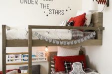 a shared lumbermen inspired kid’s bedroom done in black, red and white with much light-colored wood