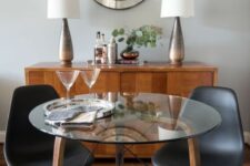a small round table with wooden and metal legs and a glass tabletop for a cozy dining space or breakfast nook