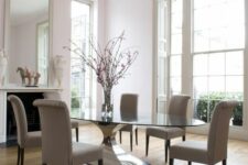 an exquisite modern dining table with a large andstable polished metal base and an oval tabletop is a gorgeous statement for the space