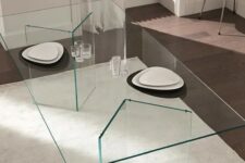 an ultra-minimalist dining table with geo glass legs and a glass tabletop, the dishes seem to be floating in the air