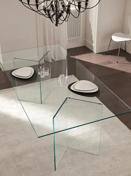 an ultra-minimalist dining table with geo glass legs and a glass tabletop, the dishes seem to be floating in the air