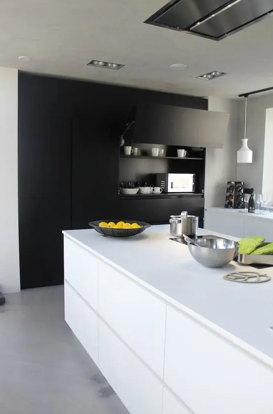 a contemporary black and white kitchen with a built-in matte storage unit, sleek white cabinets and a kitchen island, pendant lamps and a lot of natural light
