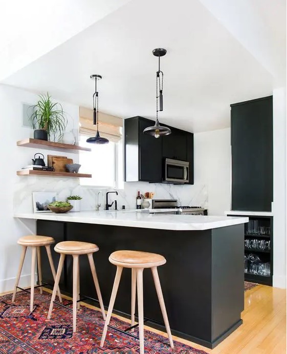 a cozy modern black and white kitchen with matte black cabinets, white marble countertops, built-in appliances, open shelves and pendant lamps