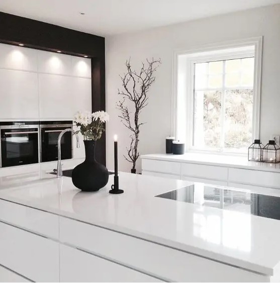 all-white kitchen with a couple of black touches looks laconically Scandinavian and very ethereal