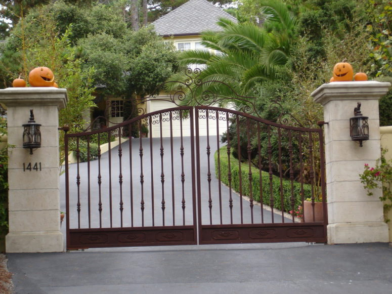 For a simple and cheerful Halloween decoration, carve a few jack-o-lanterns for your gate.
