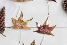 real dried leaves with gold color blocking and names is a lovely and easy decor idea for Thanksgiving