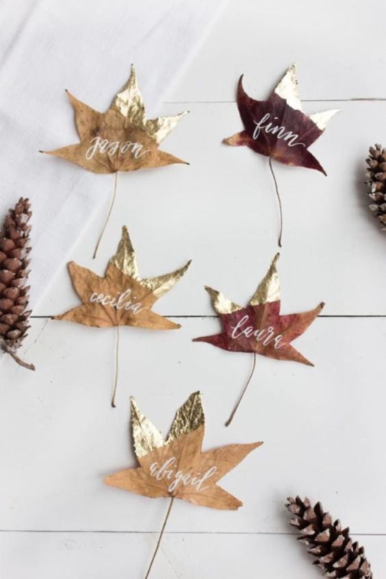 real dried leaves with gold color blocking and names is a lovely and easy decor idea for Thanksgiving