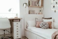 a chic neutral teen room with wall-mounted shelves, a comfy white bed with lots of pillows, a desk and a white chair plus potted plants