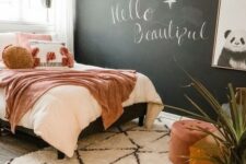 a cute girl’s room with a chalkboard wall
