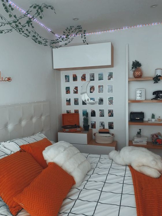 a chic teen room with a neutral bed, some storage units, lights, a gallery wall and floating shelves plus bright bedding