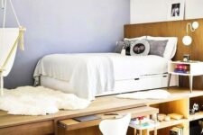a contemporary teen bedroom with a sleeping space on a platform, a desk space that can be hidden and much storage space