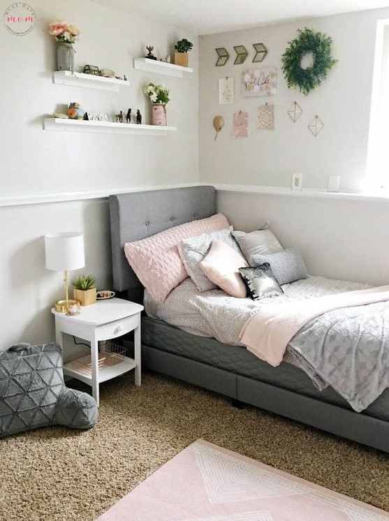 a contemporary teen room with a grey upholstered bed, layered rugs, soft pillows and a gallery wall