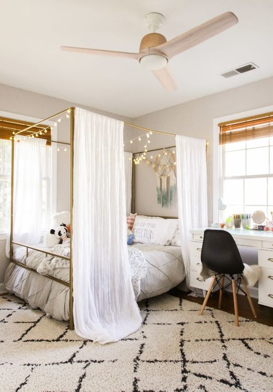 a cool teen room with a large canopy bed with lights, a white desk, a black chair and shades is a pretty space