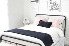 a lovely teen bedroom with a black metal bed, contrasting bedding, a pretty gallery wall and a pink faux fur bench