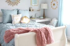 a pastel bedroom with a white bed and pastel bedding, blue curtains, a white desk as a nightstand, a white chair, a clock, a mirror and a table lamp