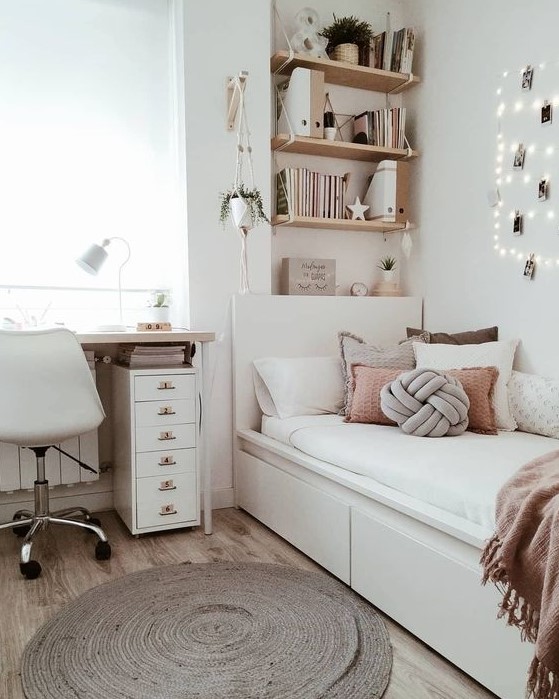 a stylish modern teen girl bedroom in neutrals, with dusty pink touches, lights, a jute rug and potted greenery