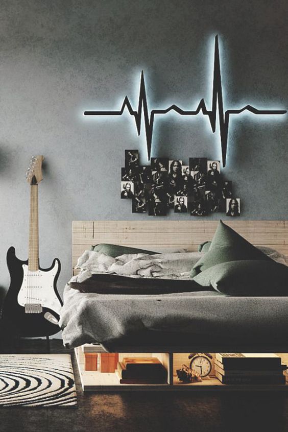 a dark and moody teen bedroom with a neon, a gallery wall, a wooden bed with storage and lights