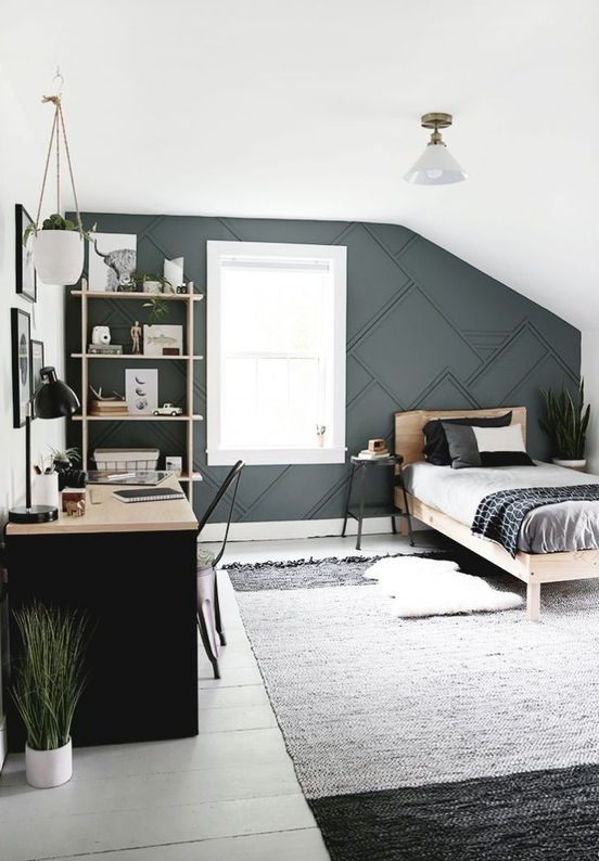 a contemporary teen bedroom with a 3D graphic wall, a black desk, a monochromatic rug and wooden furniture