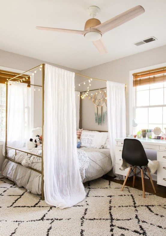 a cool teen room with a large canopy bed with lights, a white desk, a black chair and shades is a pretty space