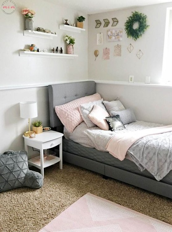 a modern farmhouse teen room with a grey upholstered bed, layered rugs, soft pillows and a gallery wall