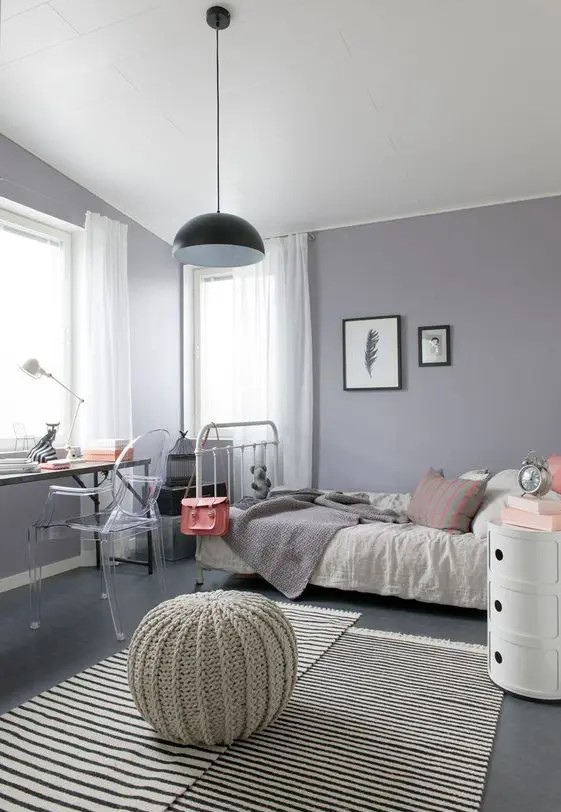 a modern grey and lilac teen girl bedroom with eclectic furniture, neutral textiles and a pendant lamp