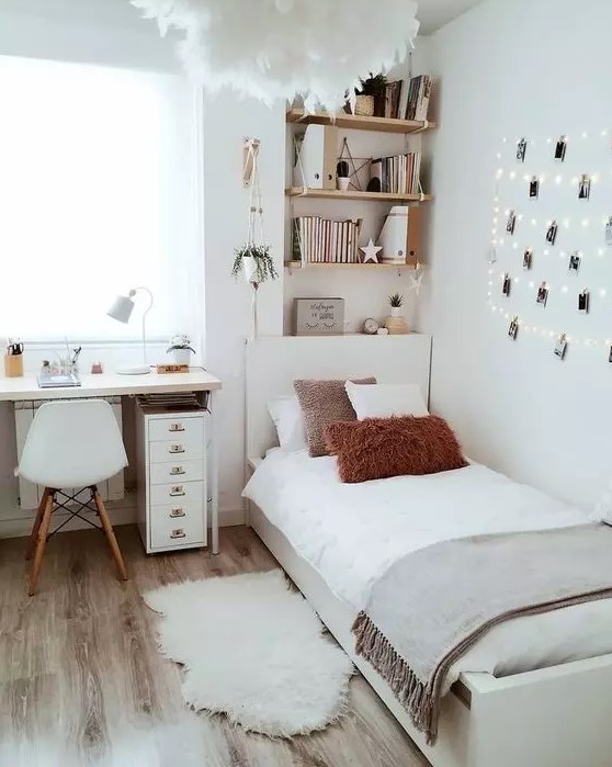 a serene Scandinavian teen bedroom with shelves, a desk, a bed, neutral textiles, a gallery wall with string lights and a fluffy lamp