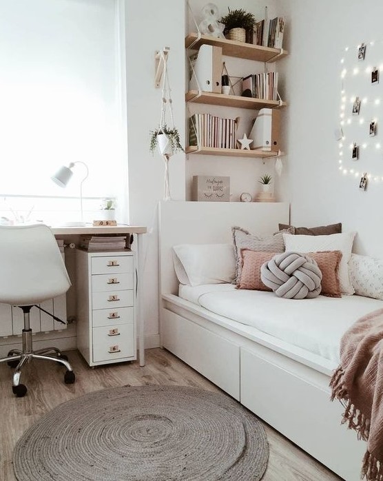 a stylish modern teen girl bedroom in neutrals, with dusty pink touches, lights, a jute rug and potted greenery