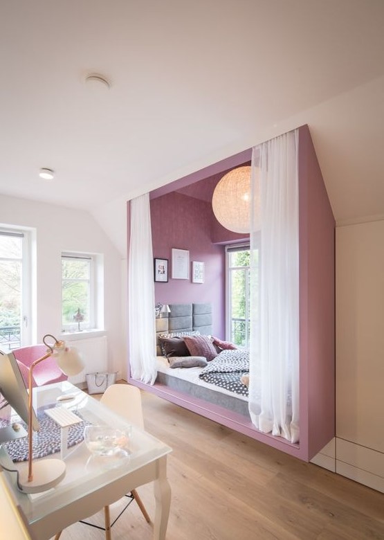 an ultra-modern and bold teen girl bedroom with a purple alcove sleeping space by the window and a white studying zone