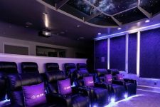 a jaw-dropping home theater with deep purple walls and a starry sky ceiling, black leather chairs, built-in lights is a chic space