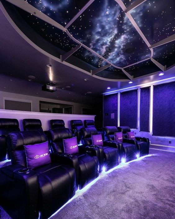 a jaw-dropping home theater with deep purple walls and a starry sky ceiling, black leather chairs, built-in lights is a chic space