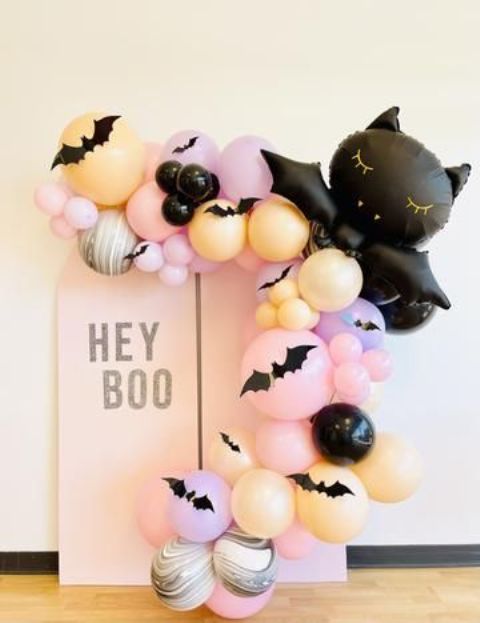 a Halloween kids' party decoration with pastel balloons and a black balloon cat is amazing for celebrating