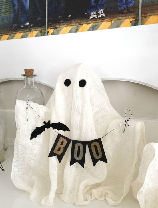 a fun cheesecloth ghost with a banner will be a nice idea for a kids' Halloween party