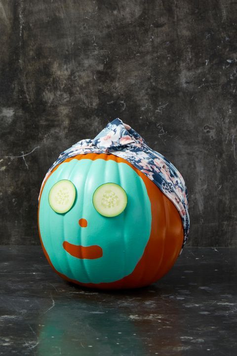 a funny no carved Halloween pumpkin with a face mask, cucumber slices and a head wrap is a lovely and cute idea