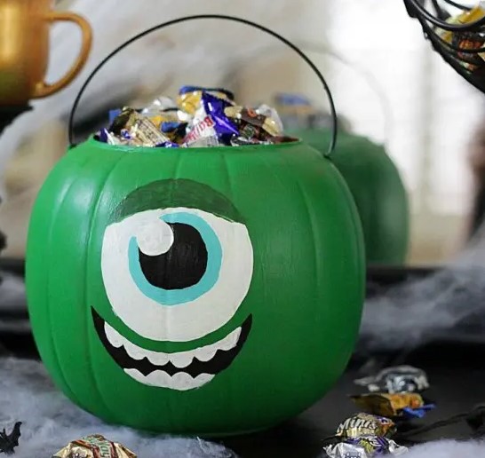 a green pumpkin monster filled with candies is inspired by Monster Corporation and looks super cool