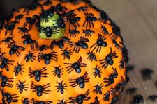 a pumpkin covered with black spiders is a cool idea for Halloween decor and it can be made in minutes, very easily and fast