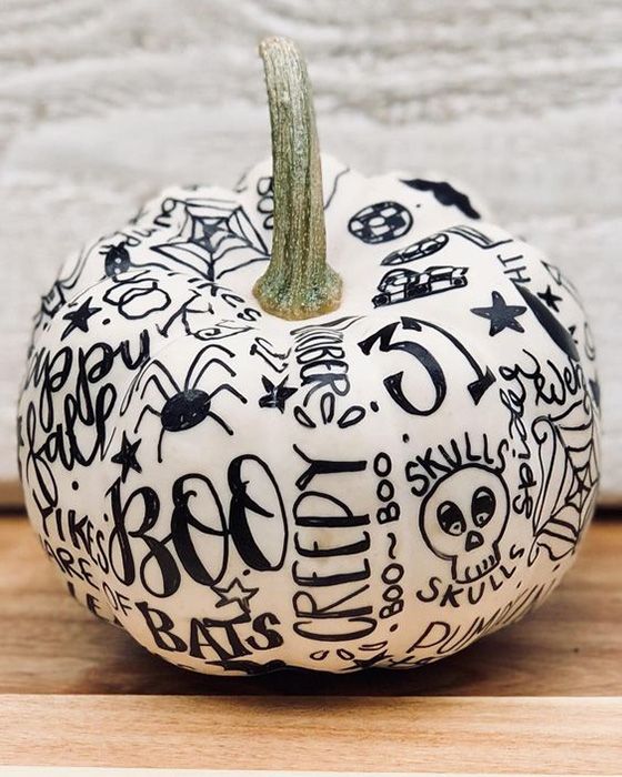 a simple white pumpkin decorated with a black sharpie is a very cute and lovely idea to rock for Halloween