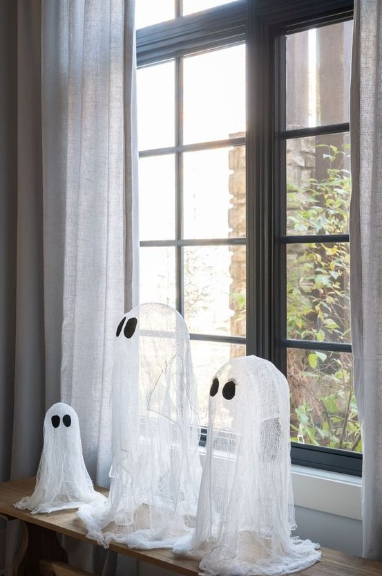 an arrangement of cheesecloth ghosts is a lovely idea for Halloween, great for kids' parties