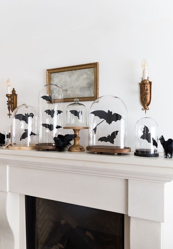 black paper bats in cloches and on the mantel are great to style it for Halloween, and they are easy to craft