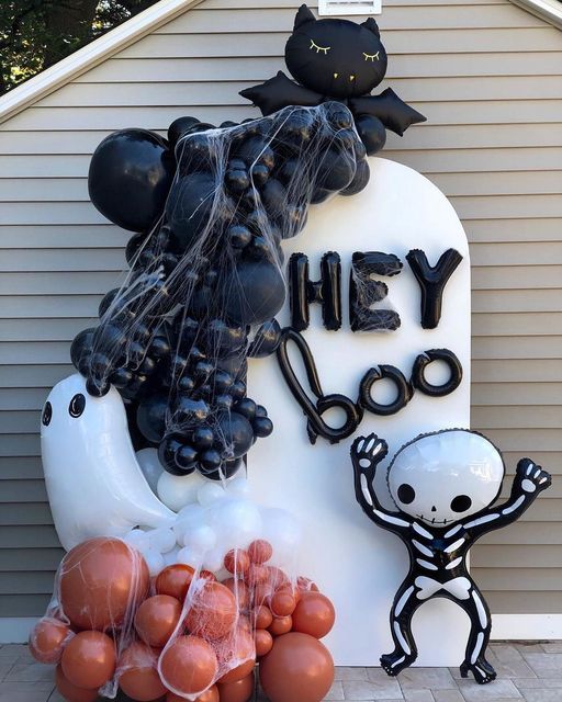 bold balloon Halloween decor with a skeleton, a ghost, a black cat and some words is a super cool and fun idea