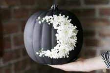 go for creative art decorating your matte black pumpkin with white blooms like that – this isn’t a durable decoration but a very cool one
