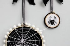 modern Halloween hoop art with spiderweb and a spider, pompoms and large bows