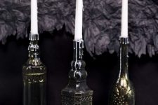 vintage bottles painted black and bronze to make the look like refined metal candleholders are chic and elegant
