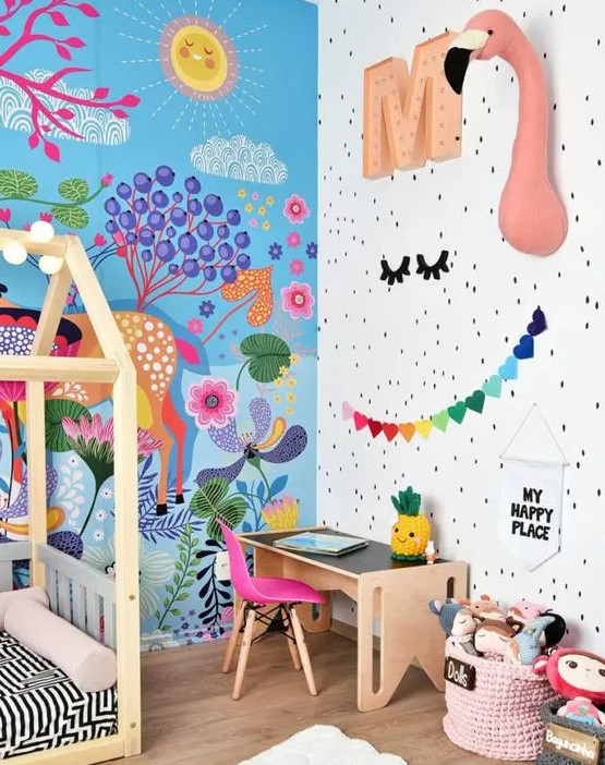 a beautiful and bold kid's room with a bright painted wall, faux taxidermy, bold garlands and toys and a hot pink chair