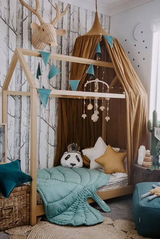 a beautiful forest-inspired kids' room with an unique bed is lively yet not too bright, with a perfect balance